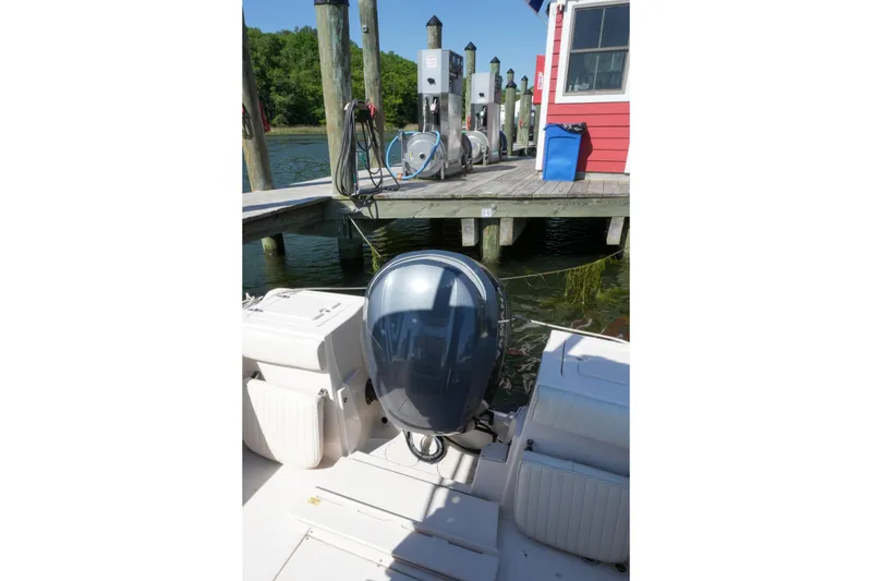 Slide: The Image of 2003 Grady-White Fisherman 222 boat docked near a red building with fuel pumps. - 3