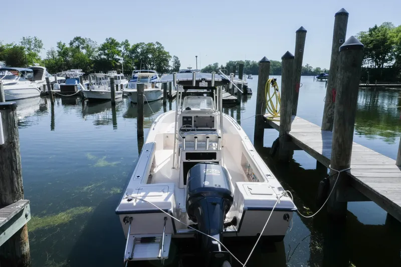 Slide: The Image of 2003 Grady-White Fisherman 222 boat docked at a marina with other vessels. - 5