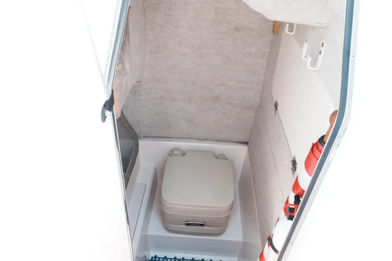Slide: The Image of 2003 Grady-White Fisherman 222 boat interior with portable toilet and storage. - 9