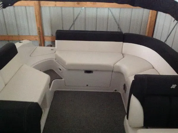 Slide: The Image of Interior of a 2013 Four Winns SL242 boat with seating area. - 16