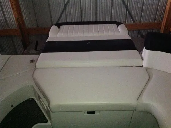 Slide: The Image of Rear view of a 2013 Four Winns SL242 boat in storage. - 17