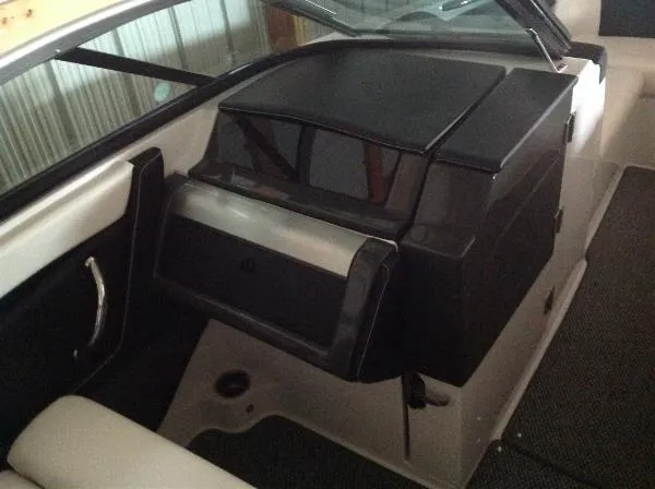 Slide: The Image of Interior of a 2013 Four Winns SL242 boat with black dashboard. - 18