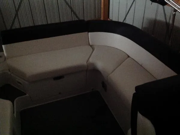 Slide: The Image of Interior of a 2013 Four Winns SL242 boat with cushioned seating. - 22