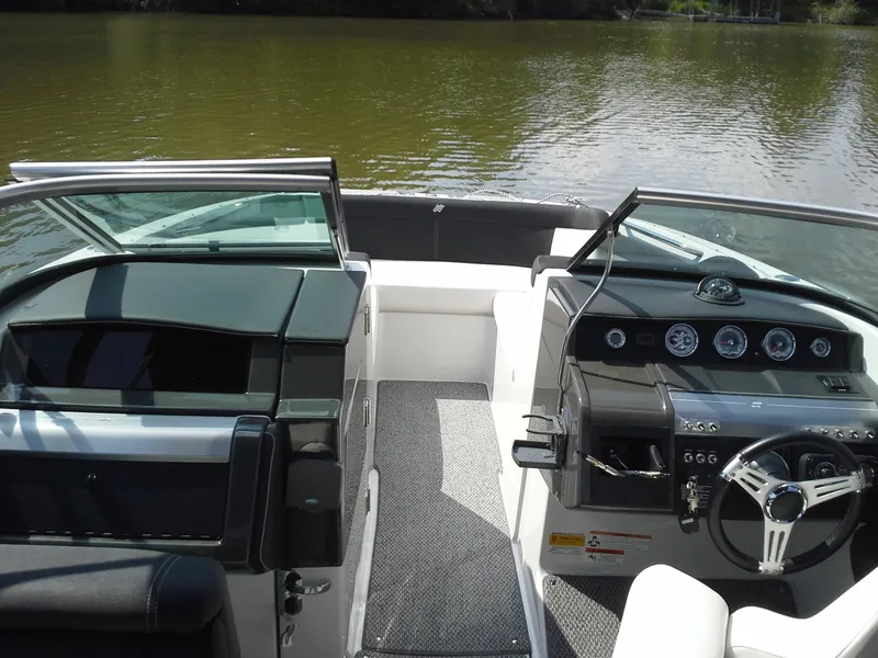 Slide: The Image of Interior view of a 2013 Four Winns SL242 boat on a calm lake. - 3
