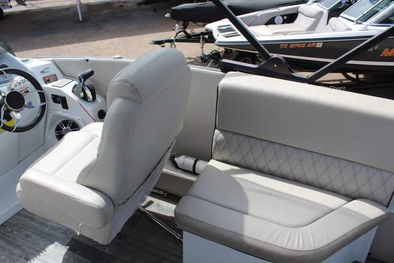Slide: The Image of 2019 Crest Savannah 250 SLRC boat interior with steering wheel and seating. - 10