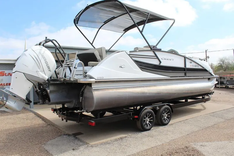Slide: The Image of 2019 Crest Savannah 250 SLRC pontoon boat with Mercury outboard engine on trailer. - 2