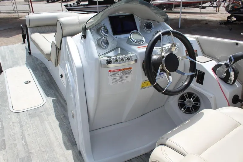 Slide: The Image of 2019 Crest Savannah 250 SLRC boat interior with steering wheel and control panel. - 22