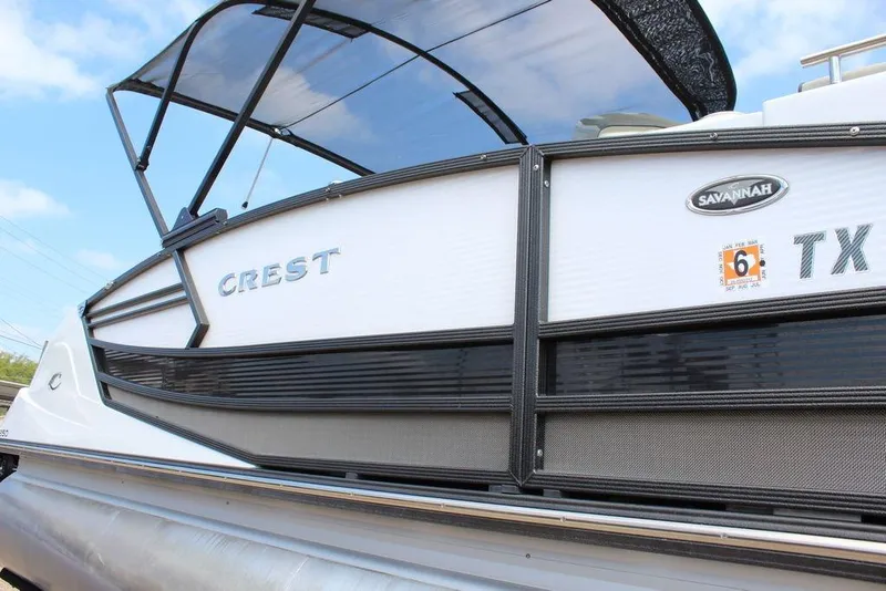 Slide: The Image of 2019 Crest Savannah 250 SLRC pontoon boat with sleek design and canopy. - 26