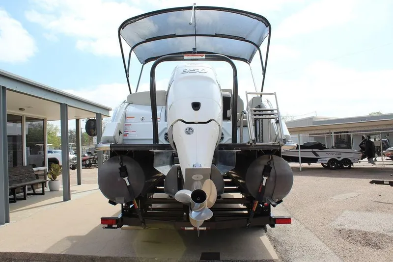 Slide: The Image of 2019 Crest Savannah 250 SLRC pontoon boat rear view with dual engines and canopy. - 6