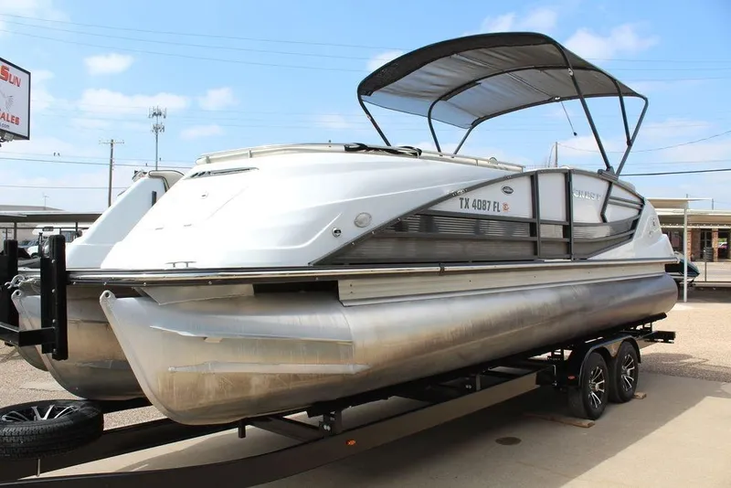 Slide: The Image of 2019 Crest Savannah 250 SLRC pontoon boat on trailer, featuring sleek design and canopy. - 9
