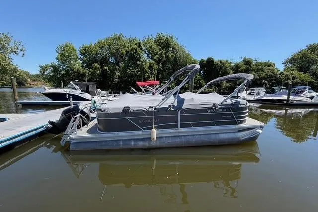 The Image of 2022 Godfrey Sweetwater 2286 SBX pontoon boat docked on a sunny day. - 0