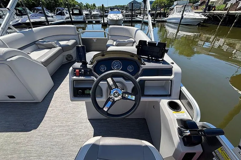 Slide: The Image of Interior view of 2022 Godfrey Sweetwater 2286 SBX pontoon boat at a marina. - 10