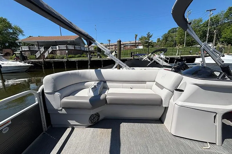 Slide: The Image of 2022 Godfrey Sweetwater 2286 SBX pontoon boat interior with comfortable seating and scenic marina view. - 14