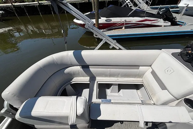 Slide: The Image of 2022 Godfrey Sweetwater 2286 SBX pontoon boat interior with white seating and storage compartments. - 15