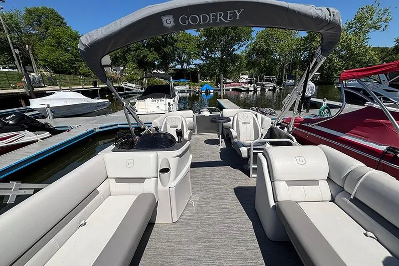 Slide: The Image of 2022 Godfrey Sweetwater 2286 SBX pontoon boat with spacious seating at a marina. - 16