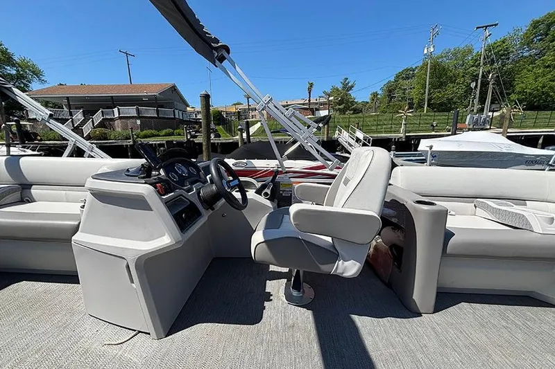 Slide: The Image of 2022 Godfrey Sweetwater 2286 SBX pontoon boat interior with helm and seating. - 8