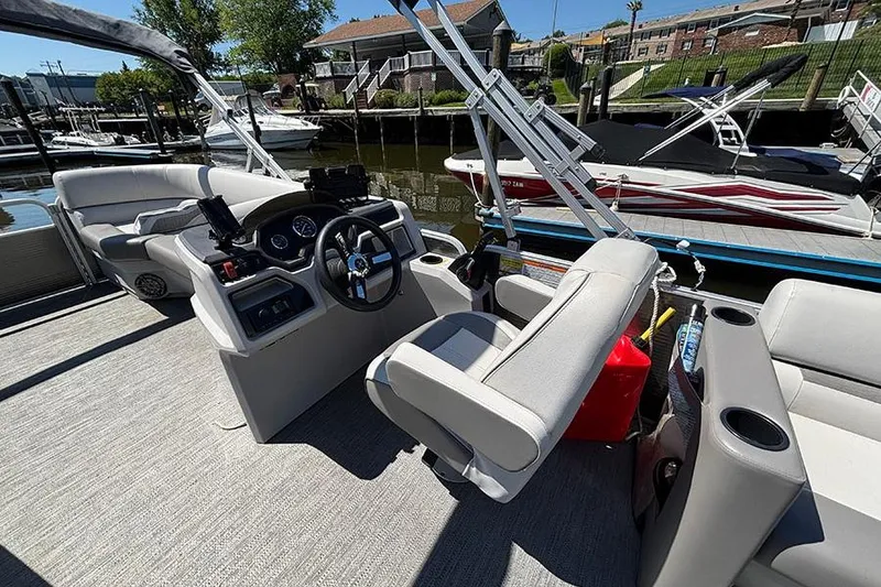 Slide: The Image of 2022 Godfrey Sweetwater 2286 SBX pontoon boat interior with steering console and seating. - 9