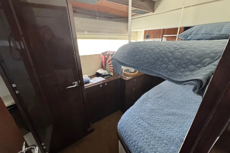 Slide: The Image of 2007 Marquis 55 LS yacht exterior with sleek design and visible branding. - 10