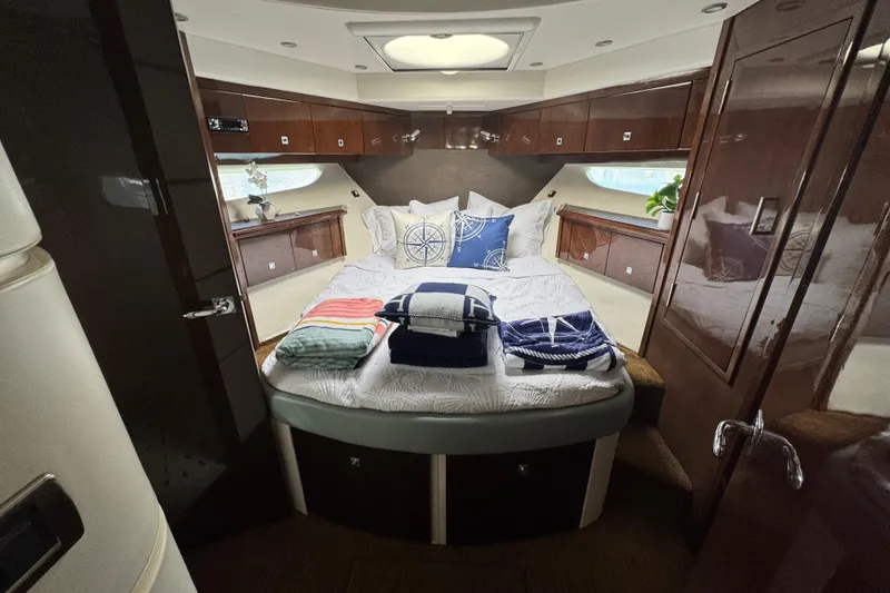 Slide: The Image of 2007 Marquis 55 LS yacht with sleek design on open water under blue sky. - 12