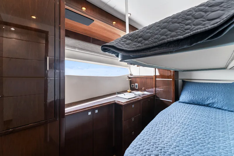 Slide: The Image of Luxurious interior of 2007 Marquis 55 LS yacht with elegant wood finishes and cozy bedding. - 23
