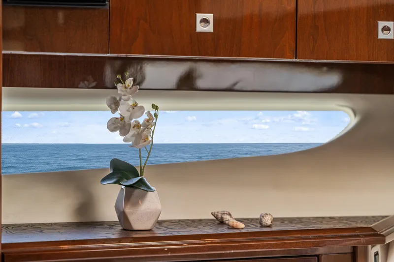 Slide: The Image of Luxurious 2007 Marquis 55 LS yacht interior with ocean view, featuring elegant decor and wooden cabinetry. - 28