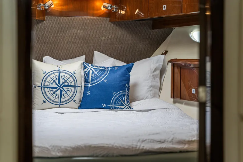 Slide: The Image of Cozy cabin interior of 2007 Marquis 55 LS yacht with nautical-themed pillows. - 29