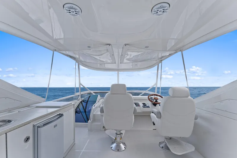 Slide: The Image of Luxurious 2007 Marquis 55 LS yacht interior with ocean view, featuring white seating and helm. - 34