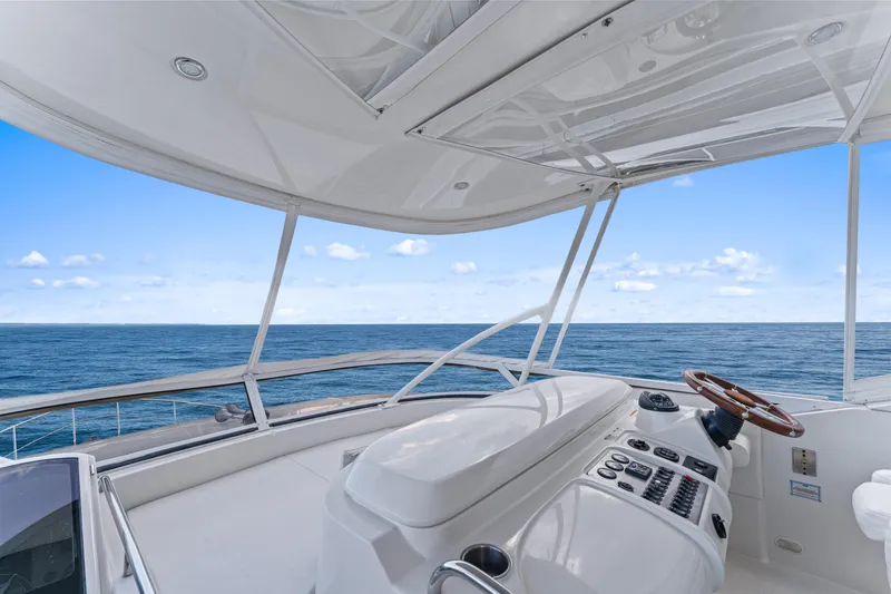 Slide: The Image of Cockpit view of 2007 Marquis 55 LS yacht overlooking the ocean under a clear sky. - 35