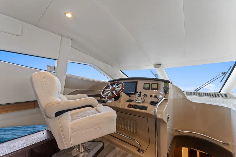 Slide: The Image of Luxurious helm of a 2007 Marquis 55 LS yacht with leather captain's chair and modern controls. - 40