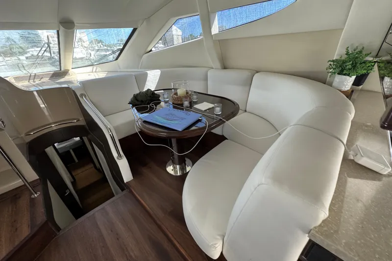 Slide: The Image of 2007 Marquis 55 LS yacht docked in a scenic marina at sunset. - 5