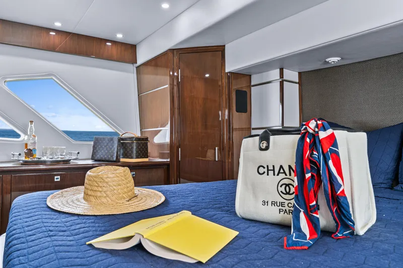 Slide: The Image of Luxurious 2007 Marquis 55 LS yacht cabin with ocean view, stylish decor, and elegant accessories. - 55
