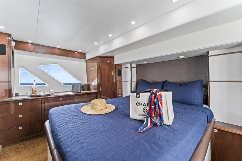 Slide: The Image of Luxurious 2007 Marquis 55 LS yacht bedroom with elegant decor and ocean view windows. - 56