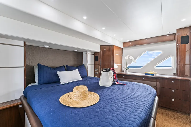 Slide: The Image of Luxurious 2007 Marquis 55 LS yacht bedroom with elegant decor and ocean view windows. - 57
