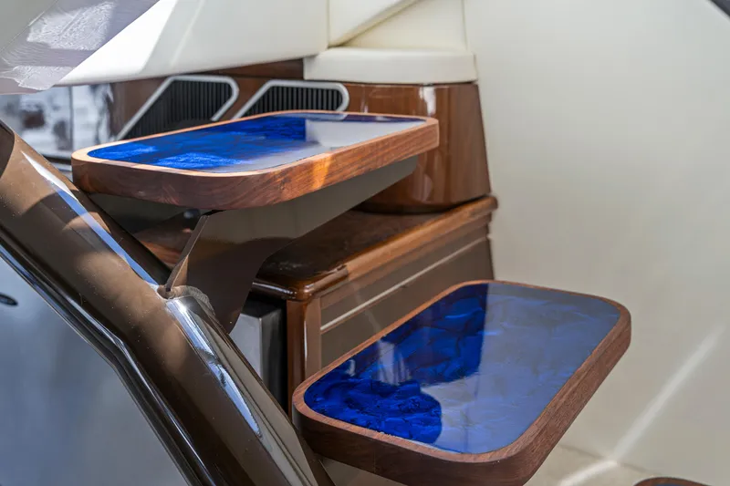 Slide: The Image of Interior of 2007 Marquis 55 LS yacht with elegant blue-topped wooden tables. - 63