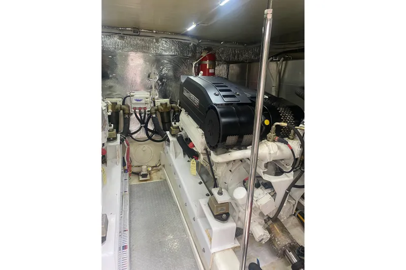 Slide: The Image of Engine room of a 2007 Marquis 55 LS yacht, featuring mechanical components and equipment. - 69