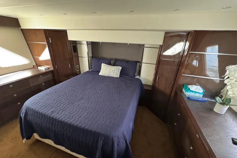 Slide: The Image of 2007 Marquis 55 LS yacht cruising on open water near a coastal shoreline. - 7