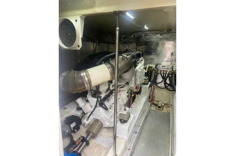 Slide: The Image of Engine room of a 2007 Marquis 55 LS yacht, showcasing mechanical components and systems. - 70