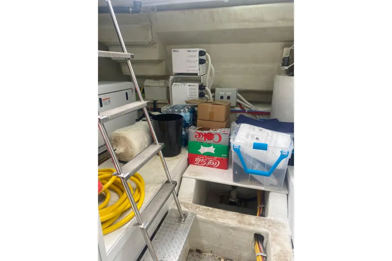 Slide: The Image of Engine room of a 2007 Marquis 55 LS yacht with storage items and equipment. - 74