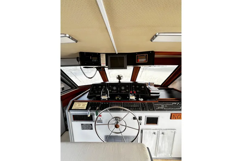Slide: The Image of 1988 Chris Craft Constellation yacht helm with steering wheel and navigation controls. - 4