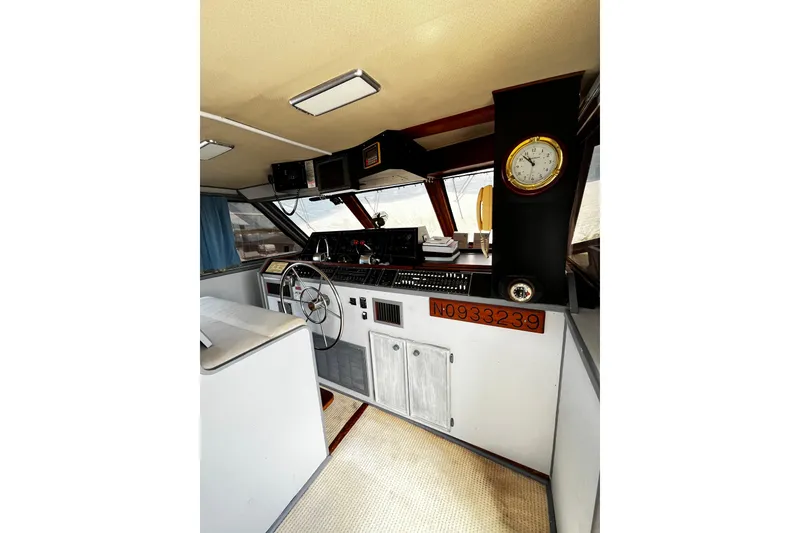 Slide: The Image of 1988 Chris Craft Constellation boat interior with steering wheel and navigation instruments. - 3