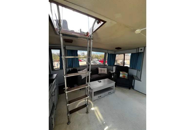 Slide: The Image of Interior of 1988 Chris Craft Constellation yacht with ladder and seating area. - 7