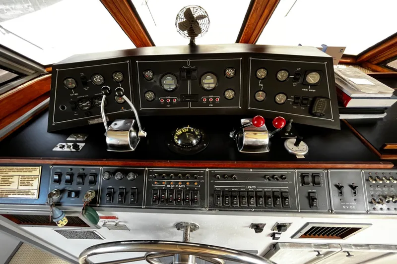 Slide: The Image of Control panel of a 1988 Chris Craft Constellation boat, featuring gauges and switches. - 5