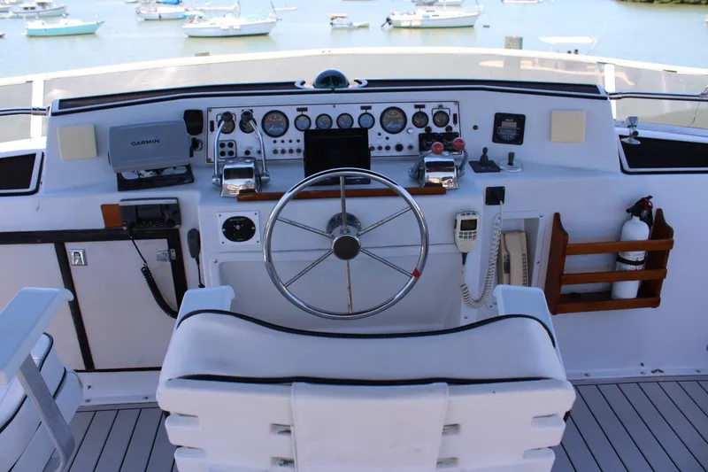 Slide: The Image of Cockpit of 1988 Chris Craft Constellation yacht with steering wheel and navigation instruments. - 12