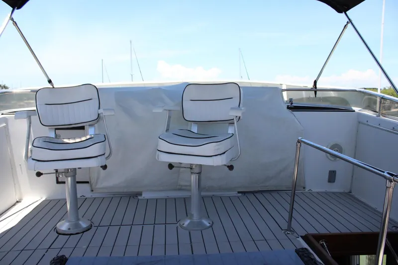Slide: The Image of 1988 Chris Craft Constellation yacht deck with two white captain's chairs. - 11