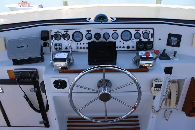 Slide: The Image of Helm of 1988 Chris Craft Constellation with Garmin navigation and classic controls. - 13