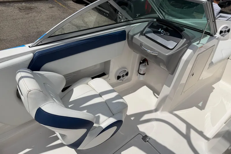 Slide: The Image of 2017 Chaparral 19 H2O Sport boat interior with white and blue seating and dashboard. - 10