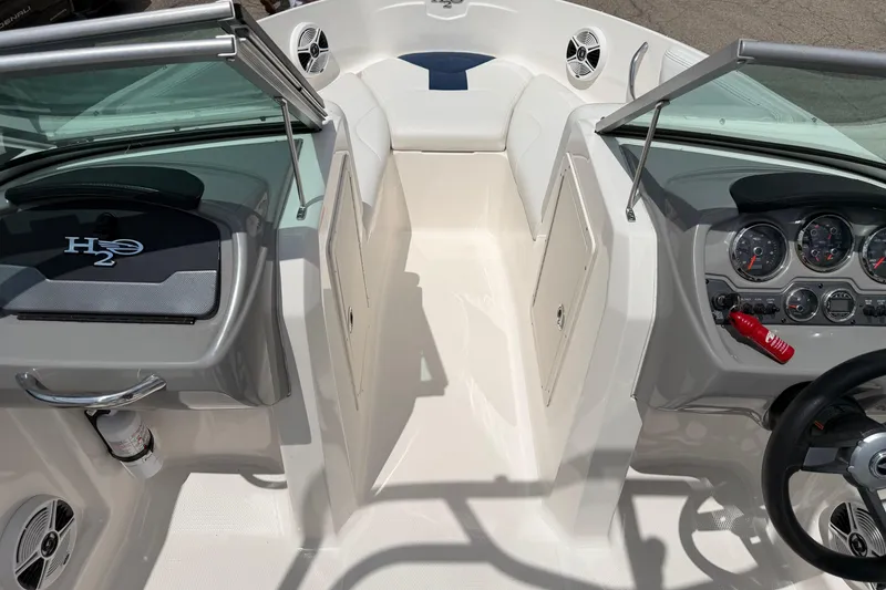 Slide: The Image of 2017 Chaparral 19 H2O Sport boat interior with dashboard and seating area. - 12