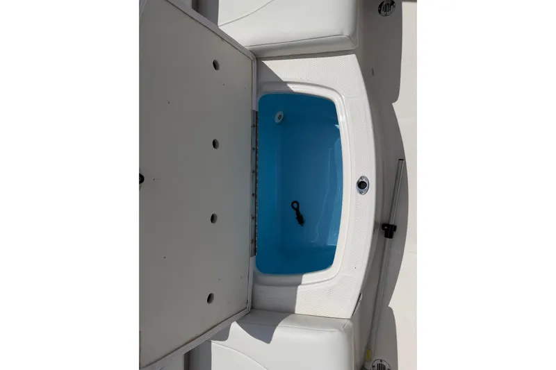 Slide: The Image of 2017 Chaparral 19 H2O Sport boat storage compartment with open lid and blue interior. - 13
