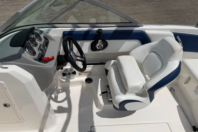 Slide: The Image of 2017 Chaparral 19 H2O Sport boat interior with steering wheel and dashboard controls. - 17