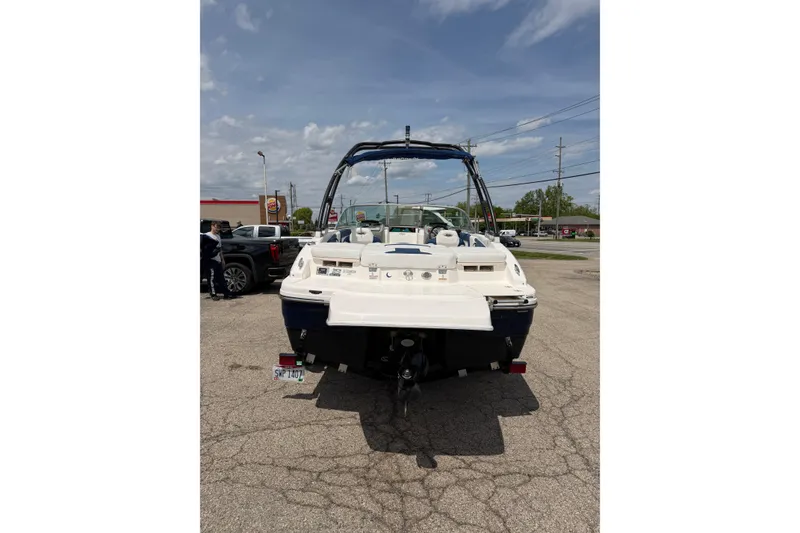 Slide: The Image of 2017 Chaparral 19 H2O Sport boat parked in a lot, rear view. - 2